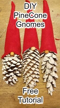 three pine cone gnomes sitting next to each other on top of a wooden table