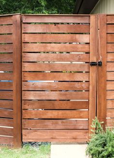 a wooden fence with vertical slats on the sides and an opening at the top