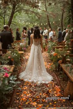 a woman in a wedding dress is walking down the aisle