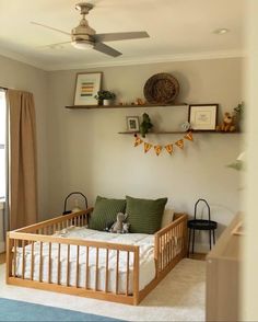 a bedroom with a bed, ceiling fan and shelves on the wall above it's headboard