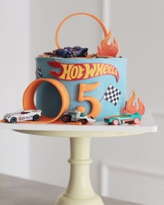 a birthday cake with hot wheels on top