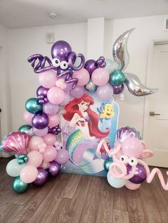 the little mermaid balloon arch is decorated with balloons