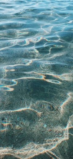 the water is very clear and blue with little ripples on it's surface