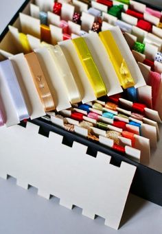 many different colored pieces of paper sitting on top of each other next to each other