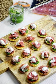 small appetizers are arranged on a cutting board