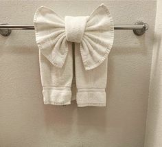 a white towel hanging on a metal bar in a bathroom