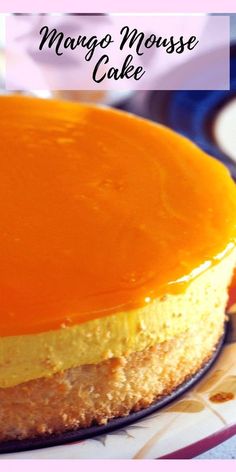 a close up of a cake on a plate with the words mango mousse cake