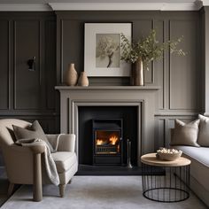 a living room filled with furniture and a fire place next to a wall mounted fireplace