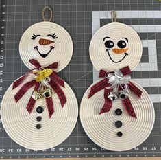 two snowmen made out of rope with bells