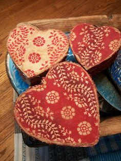 four heart shaped cookies in a wooden box