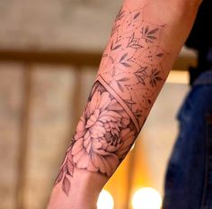 a person with a flower tattoo on their arm