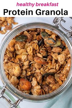 a glass jar filled with granola on top of a white tablecloth and text overlay reads healthy breakfast protein granola