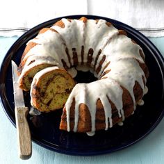 a bundt cake with white icing on a blue plate