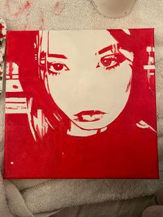 a red and white painting with a woman's face on it