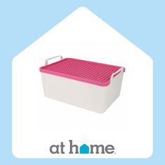 a pink and white container with the words at home on it