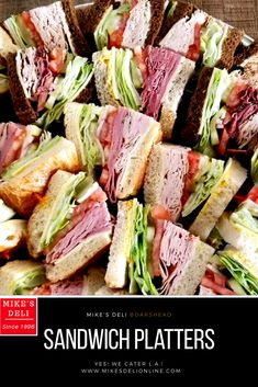 a bunch of sandwiches that are sitting on a table with the words sandwich platters