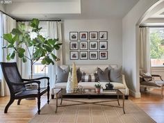 a living room filled with furniture and pictures on the wall