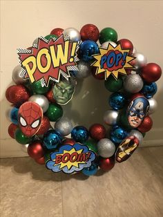 a wreath made out of christmas ornaments with the word pow on it and superheros