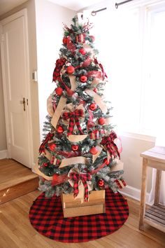 a christmas tree decorated with red and white ribbons