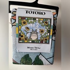 a totoro stained glass window hanging on a wall