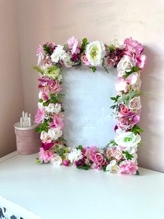 a white frame with pink and white flowers