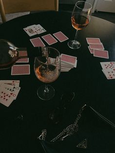 playing cards and wine are on the table