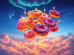 there are donuts floating in the air with candles on them and clouds around it