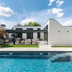 a house with a swimming pool in front of it