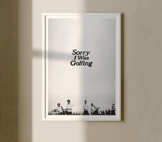 a poster hanging on the wall in front of a window that says sorry i was clothing