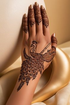 a woman's hand with henna tattoos on it