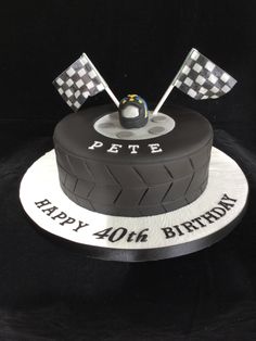 a black and white birthday cake with two flags on it's top that says pete happy 4th birthday