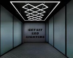 an empty hallway with the words get lit lighting on it's wall and ceiling