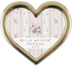 a heart shaped photo frame with flowers on the front and bottom, is shown in gold