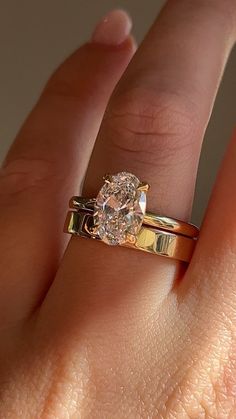 a woman's hand with a ring on it and a diamond in the middle