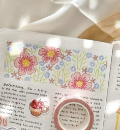 an open book with stickers on it and some writing in the pages next to it