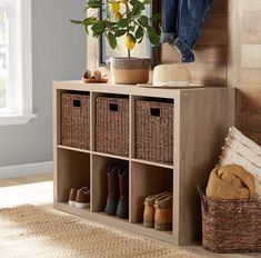 a wooden shelf with baskets and shoes on it