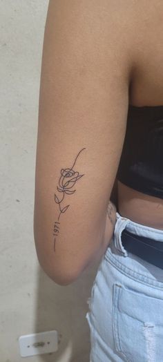 a woman with a rose tattoo on her arm