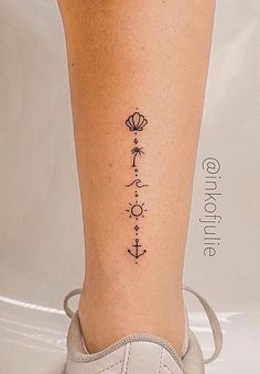 a woman's leg with a tattoo on it and an anchor in the middle