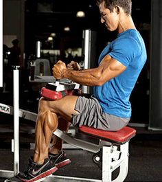 a man sitting on top of a bench working out with dumbbells in a gym