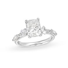 an oval cut diamond engagement ring with three stones on the band and shoulders, set in 18k white gold