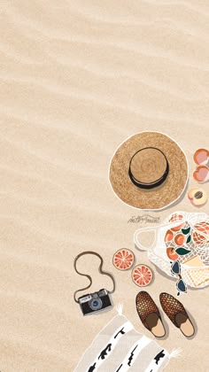 an assortment of beach items laid out on the sand