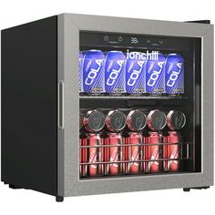 a mini fridge with six cans of soda in it