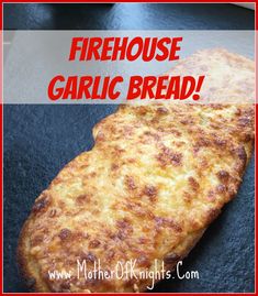 a close up of a piece of bread on a plate with the words firehouse garlic bread