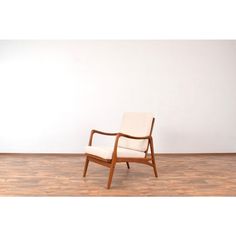 a white chair sitting on top of a hard wood floor