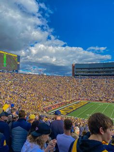 a football stadium full of people watching the game