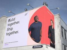 a large billboard with a man and woman standing in front of it that says build together, ship together