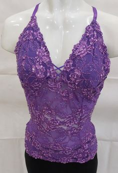 a mannequin wearing a purple top with sequins