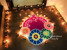 a decorated floor with candles and flowers on it