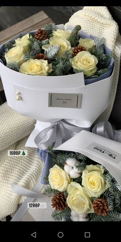 two pictures of flowers in a white box with pine cones on the top and bottom