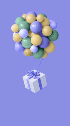 a bunch of balloons are floating in the air with a gift box on it's side